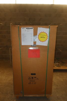 a cardboard box with a sign on it in the middle of a room