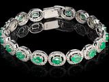 un bracelet en émeraudes et diamants posé sur un fond noir