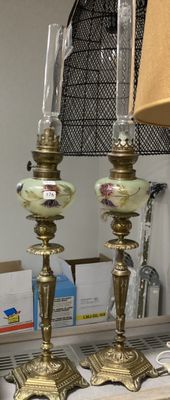 two lamps that are on a table with a lamp shade