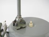a close up of a metal object on a white surface