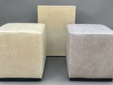three stools in different colors and sizes on a gray background
