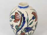 a small vase with a floral design on it
