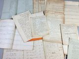 a pile of old papers that are on a table