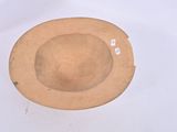 a brown hat sitting on top of a white table