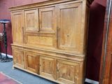 a wooden cabinet that is sitting in a room