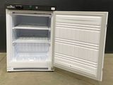 a small refrigerator with its door open on a concrete floor