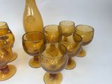 bottles and glasses are lined up on a white surface