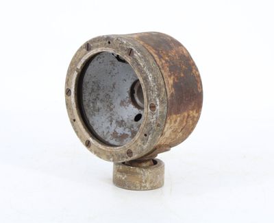 an old rusted metal object on a white surface