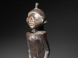 a wooden statue of a man with a helmet on his head