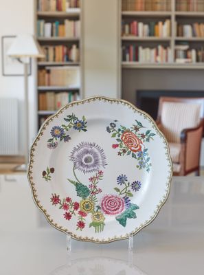 a plate with a floral design on it sitting on a table