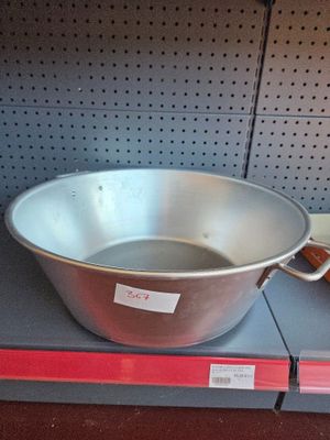 a large metal pan sitting on a shelf in a store