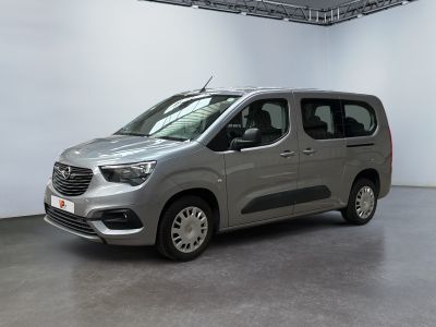 the silver van is parked in a large room with a white wall