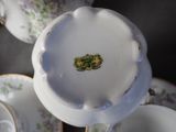a close up view of a tea set with tea cups and saucers