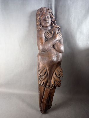 a wooden sculpture of a woman holding a child