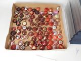 a box of buttons sitting on a table next to a stack of books