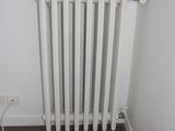 a white radiator in the corner of a room