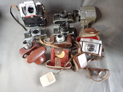 a lot of old cameras on the table together