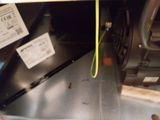 a close up of a microwave with a yellow cord attached to it