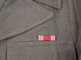 a jacket with a red and white stripe on the lapel