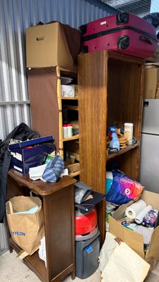 a room with a lot of boxes and a refrigerator in it