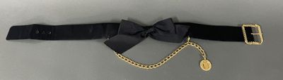 black belt with a gold chain and a black bow on it