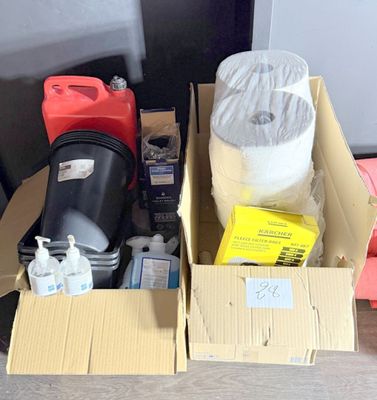 a box of items sitting on the floor next to a trash can