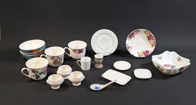 many different types of dishes and cups on the table
