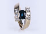 an image of a ring with a sapphire and diamonds