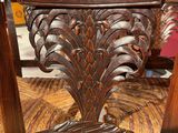 a wooden chair with a striped seat and back