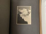 an open book with a picture of a mountain in it