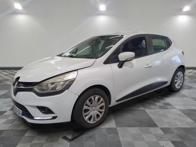 a white car is parked in a room with a checkered floor
