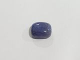 a close up of a blue stone on a white surface
