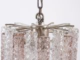 a glass chandelier hanging from a metal chain