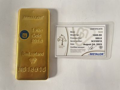 le lingot d'or se trouve à côté d'une carte d'identité métallique, posés sur une surface blanche