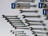 a lot of wrenches that are laying on a table