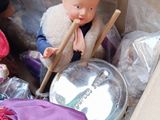 a box full of dolls and other items in it