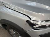 a car that has a denting on the front of it
