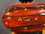 a close up of a wooden object with yellow dots on it