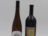 two bottles of wine sitting next to each other on a table