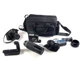 a camera, a camera bag, a camera and other items laid out on a white surface