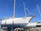 a white sailboat that is sitting on the ground