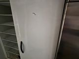 a white refrigerator in the corner of a kitchen