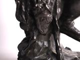 statue of a man riding a horse with a woman on his back