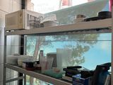 a fish tank in the middle of a kitchen with dishes on it