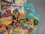 a lot of comic books sitting on a table