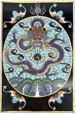 an image of a blue and black plate with a dragon on it