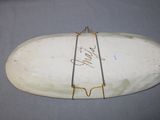 a white surfboard with writing on it on a table
