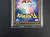 a close up of a pokemon card on a black surface