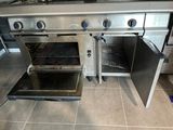 a silver oven with two open doors in a kitchen