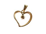 a close up of a heart shaped pendant with a flower on it